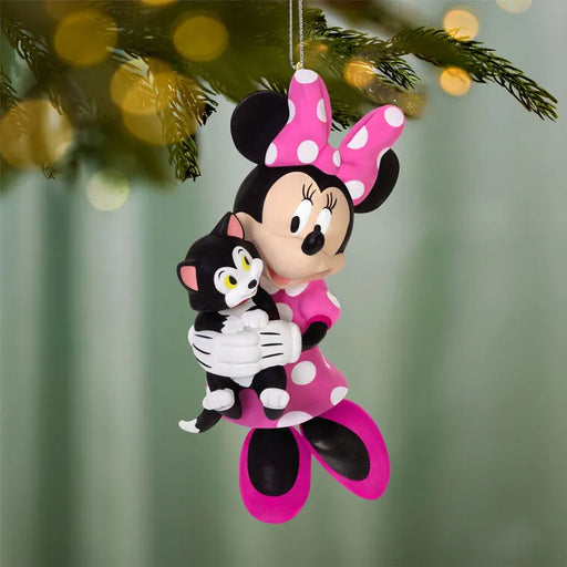 Glossy plastic Minnie Mouse ornament hanging on pine branch with Figaro cat in pink polka-dot dress