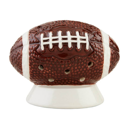 Close-up of Mud Pie ceramic football-shaped light-up sitter with cutout holes and white detailing.
