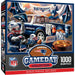 Front and side views of a 1000-piece Gameday Collection NFL jigsaw puzzle box featuring a festive Patriots-themed illustration with a blue truck, football, cooler, and fans.