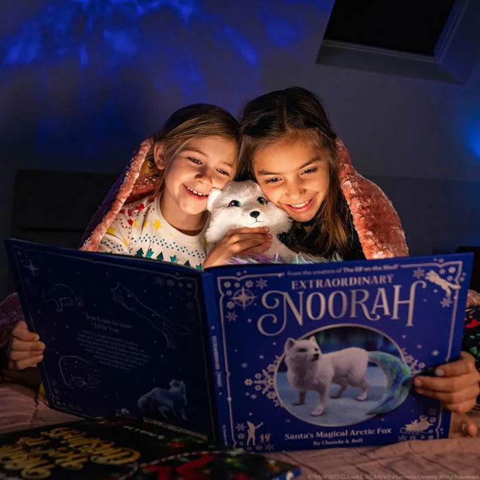 Two children reading a book titled 'Extraordinary Noorah' with a white dog on a dark background