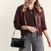This HOBO Darcy Small Crossbody Bag in Black offers a sleek look and everyday convenience in one compact design.