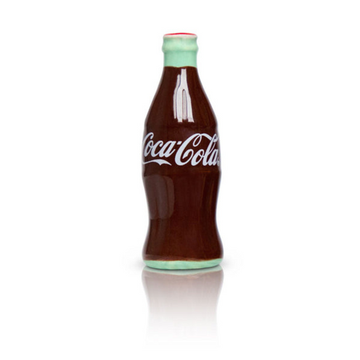 Close-up of Nora Fleming Coca-Cola bottle mini with classic red and green glass bottle design on white background