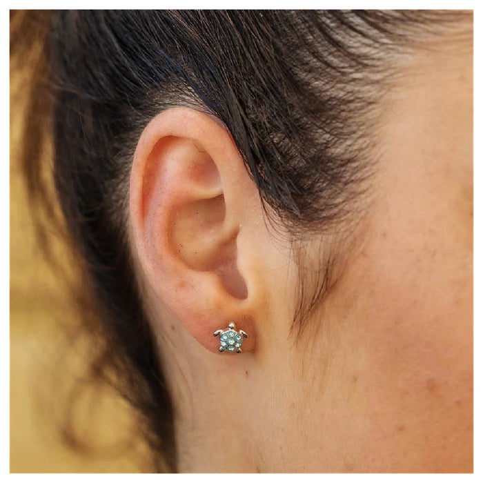 Blue turtle earrings with detailed patterns, showcasing a playful marine theme, suspended from elegant silver hooks.