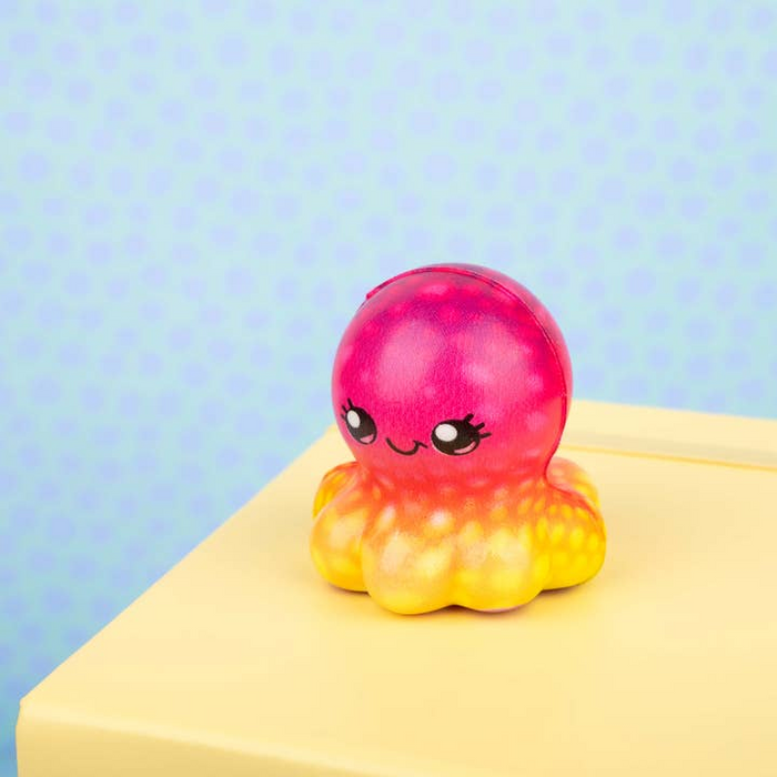 Colorful octopus-shaped toy with a pink top and yellow bottom on a light blue background