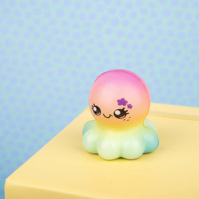 Colorful, cartoon-like character on a yellow surface with a polka dot background