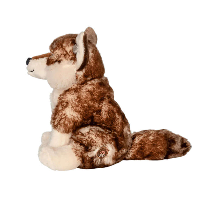 Plush toy Wolf with brown and white fur on a black background