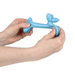 Blue dog toy shaped like a bone held by hands on a white background