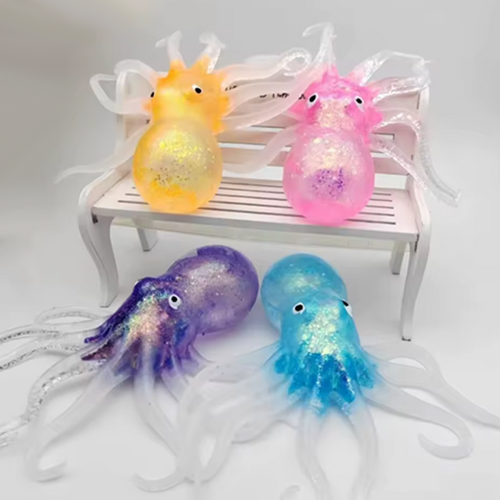 Four colorful jellyfish toys on a white bench with a light gray background
