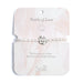 Elegant bracelet featuring lustrous pearls, symbolizing love and connection, displayed on a soft fabric background.