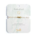 Elegant bracelet featuring pearls, symbolizing luck and charm, displayed on a soft fabric background.