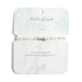 Elegant bracelet featuring pearls, symbolizing luck and charm, displayed on a soft fabric background.