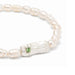 Stylish luck bracelet made of lustrous pearls, showcased against a neutral backdrop.