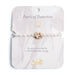 Elegant bracelet featuring pearls, symbolizing protection and beauty, displayed on a soft fabric background.