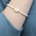 Exquisite pearls of protection bracelet, emphasizing its charm and meaning, displayed on a soft, neutral background.