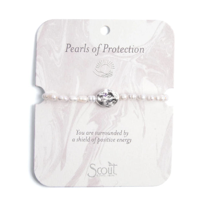 A white pearl bracelet featuring a single purple stone accent.