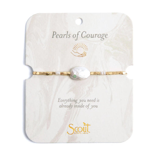 A close-up of a "pearls of courage" bracelet featuring lustrous pearls and a delicate clasp, symbolizing strength and resilience.