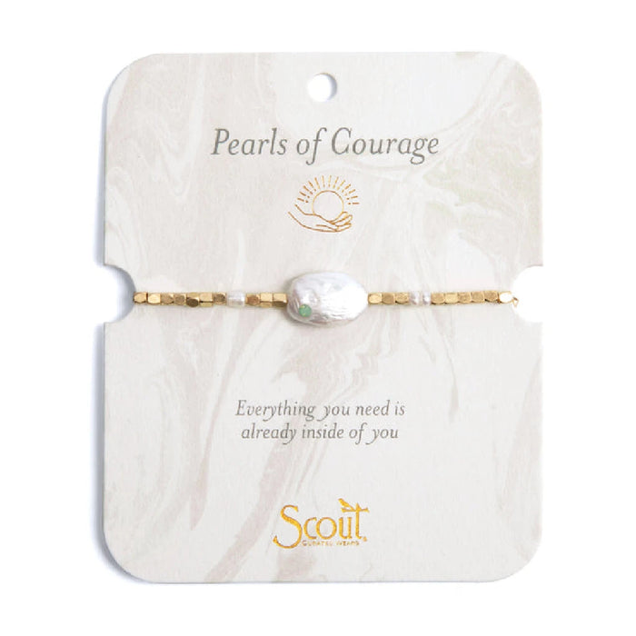 A close-up of a "pearls of courage" bracelet featuring lustrous pearls and a delicate clasp, symbolizing strength and resilience.