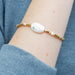 A stylish "pearls of courage" bracelet featuring gleaming pearls, representing strength and elegance in a refined accessory.