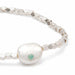 A stylish bracelet made of white pearls interspersed with vibrant green stones, ideal for formal occasions.
