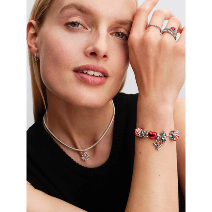 Model wearing Pandora Christmas Tree Charm on a bracelet for a festive holiday look.