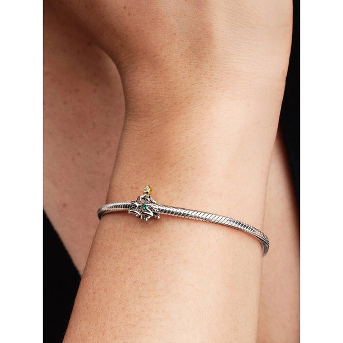 Model wearing Pandora Christmas Tree Charm on a bracelet for a festive holiday look.