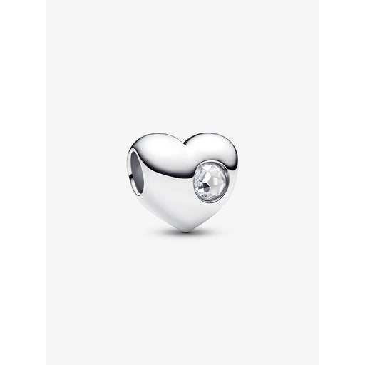 Silver heart-shaped Pandora charm with a clear round stone set on one side, displayed against a plain background.
