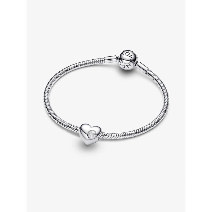 Silver snake chain bracelet featuring the engravable heart charm with a clear stone at the center.