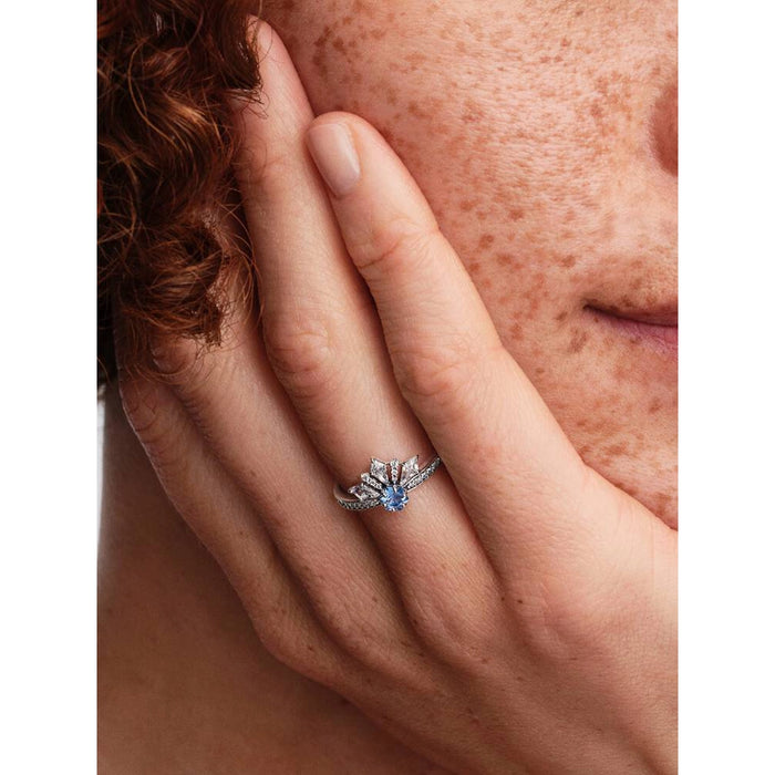 Pandora Elsa tiara ring worn on hand in lifestyle shot highlighting blue crystal crown design