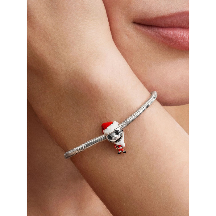 Woman wearing Pandora bracelet with Jack Skellington Santa charm styled.