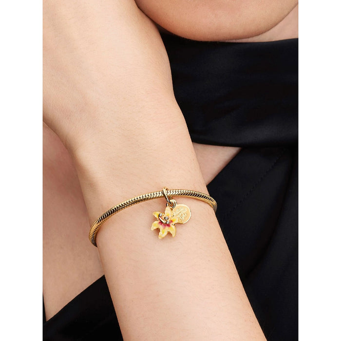 Rapunzel Sun Flower Pandora charm styled on gold snake chain bracelet, inspired by Disney’s Tangled.