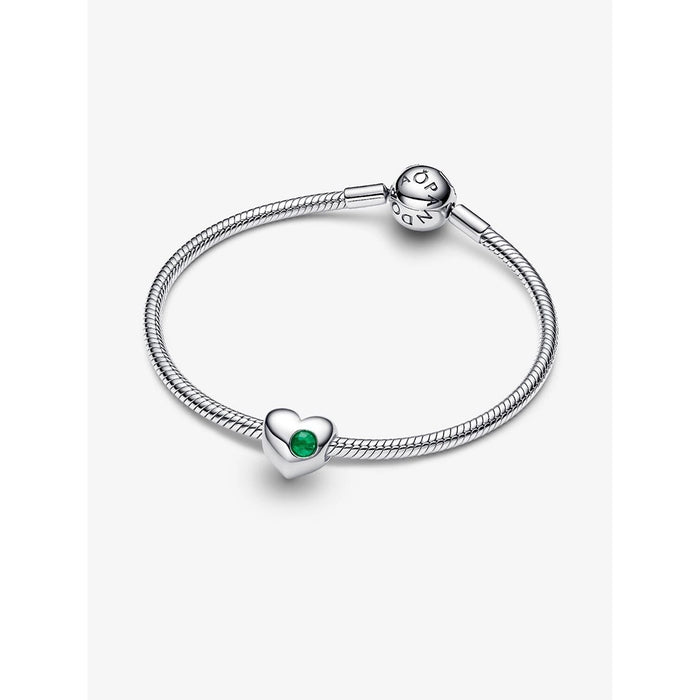 A silver Pandora bracelet featuring an engravable heart-shaped charm with a green stone at the center, displayed on a plain white background.