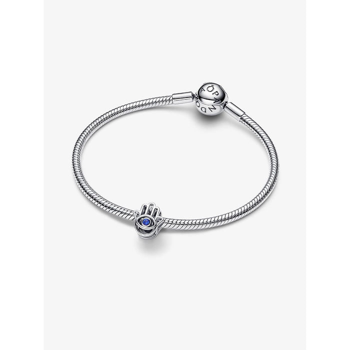 Pandora silver snake chain bracelet styled with the Hamsa Hand Charm featuring a blue stone eye.