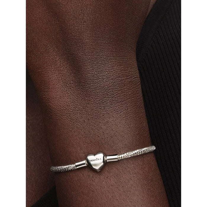 Pandora Heart Clasp Faceted Snake Chain Bracelet worn on wrist, showcasing polished heart clasp detail.