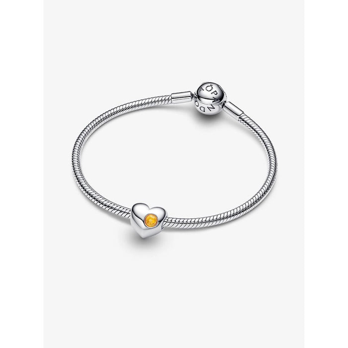 Pandora silver snake chain bracelet featuring a honey-yellow heart charm.