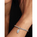 Model wearing Pandora openable coffin charm on silver bracelet, charm hanging naturally from wrist.