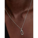 Close-up of Pandora silver oval link pendant necklace on chain, worn with black top.