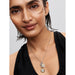 Woman wearing Pandora silver oval link necklace with attached coin charms for a personalized look.