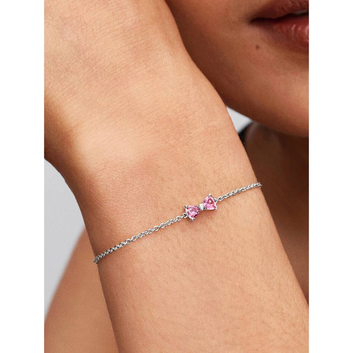 Model wearing the Pandora Pink Bow Chain Bracelet showcasing the pink bow centerpiece on a slim silver chain.