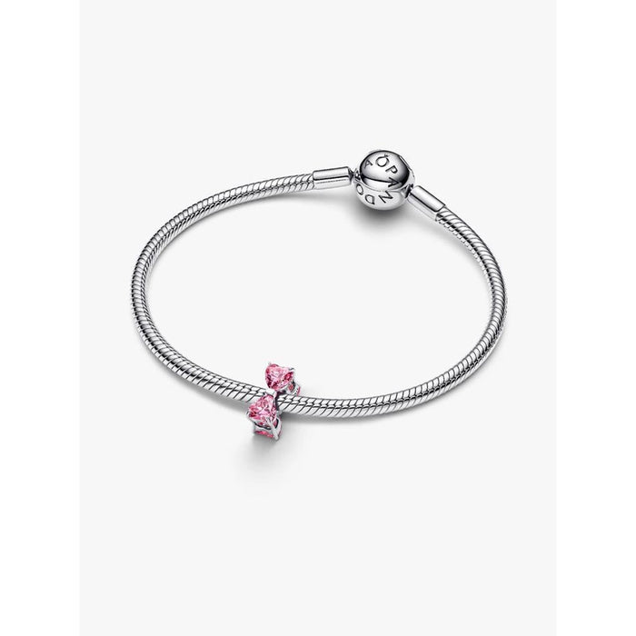 Sterling silver Pandora bracelet featuring the Pink Bow Charm with two pink heart-shaped stones.