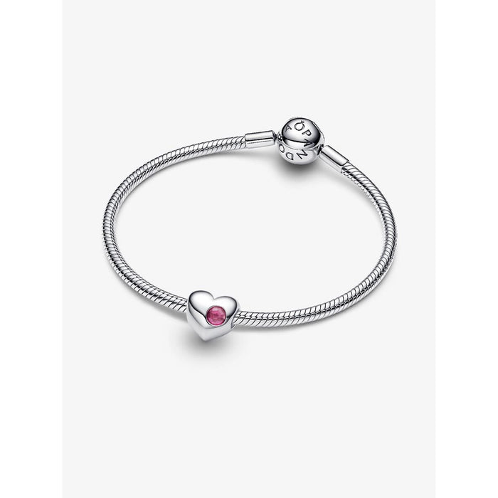Pandora sterling silver snake chain bracelet styled with a single heart charm set with a pink stone, shown against a white background.