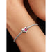 Close-up of a Pandora sterling silver bracelet featuring a heart-shaped charm with a pink stone at the center, worn on the wrist.