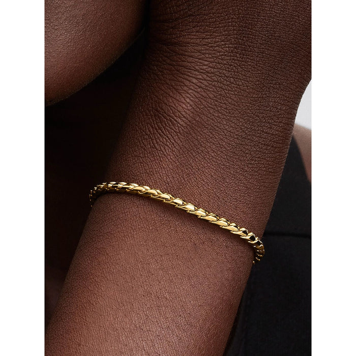 Close-up of Pandora gold woven bracelet with sleek clasp design on wrist.