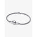 Pandora silver bracelet with engraved round clasp and woven chain, detailed product shot.
