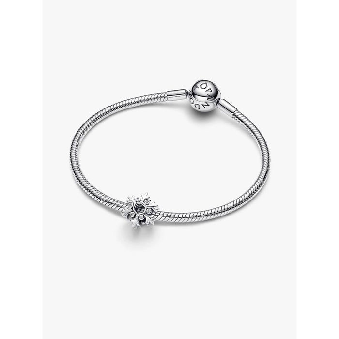 Pandora Snowflake Charm on a sterling silver Pandora Moments snake chain bracelet, product display image.