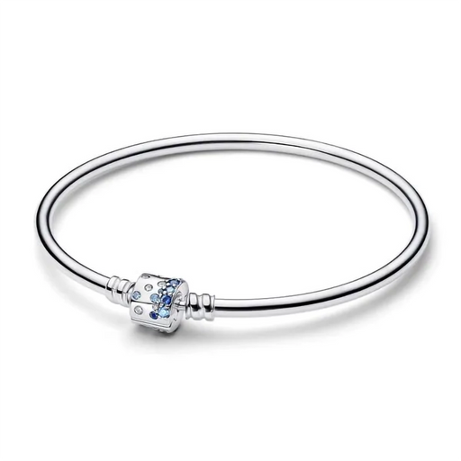 Side angle view of the silver Pandora barrel clasp bangle sparkling with blue cubic zirconia stones