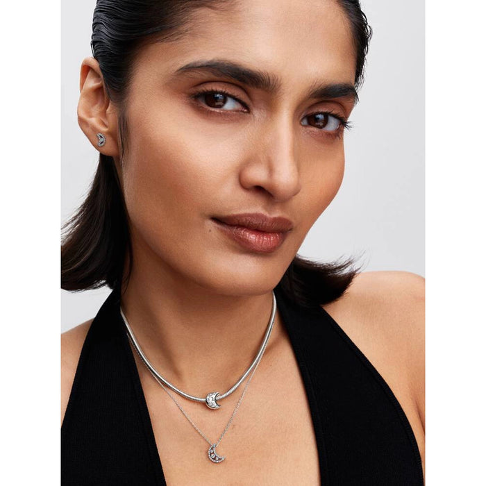 Model wearing Pandora Sparkling Moon stud earrings and matching moon necklace in sterling silver