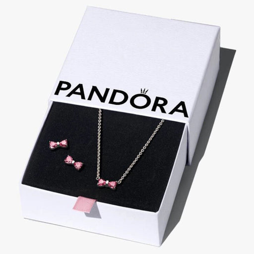 Pandora Sparkling Pink Bow Jewelry Gift Set displayed in gift box, featuring sterling silver necklace and pink bow stud earrings inside black velvet interior.