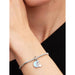Pandora Sparkling Silver Crescent Moon Dangle Charm on bracelet worn on wrist, showcasing blue enamel moon design.