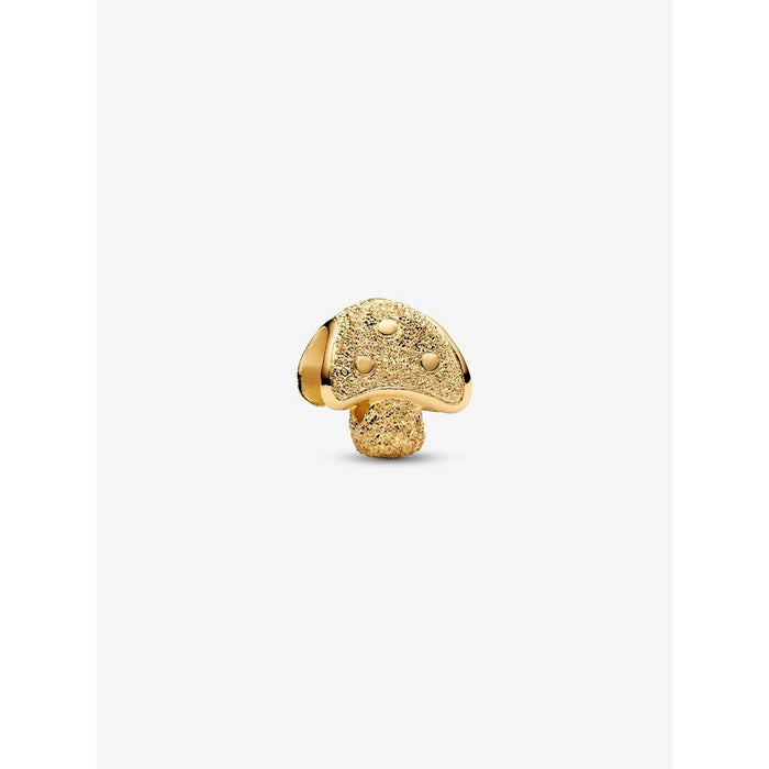 Gold mushroom charm with textured cap and dotted details on white background