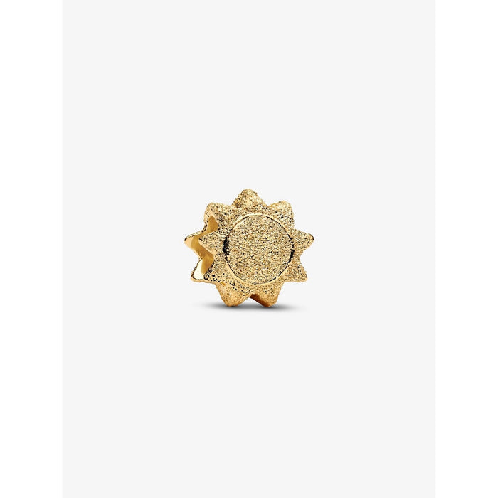 Close-up of 14k gold-plated textured sun charm with radiant detailing.